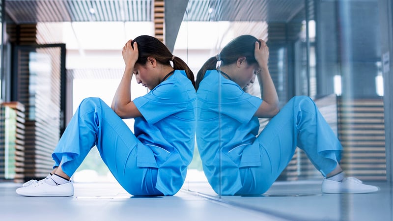 tired nurse in medical scrubs
